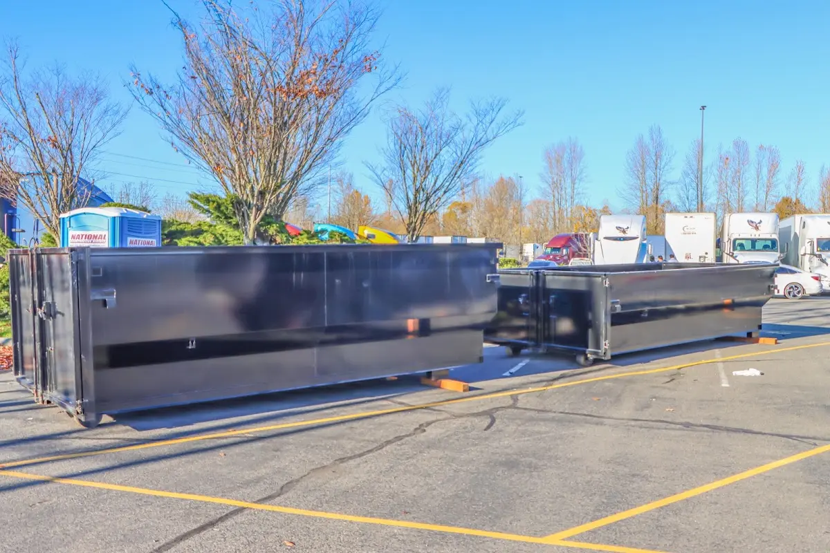 Professional dumpster rental service with roll-off container on residential driveway in California Polytechnic State University